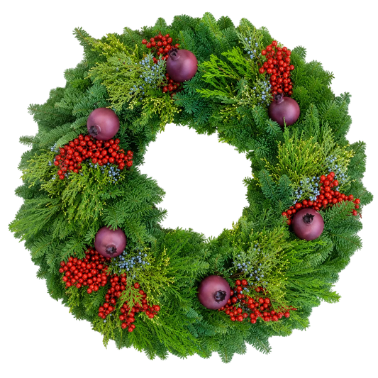 A festive green Christmas wreath decorated with red berry clusters, purple ornaments, and small blue berries on a solid white background.