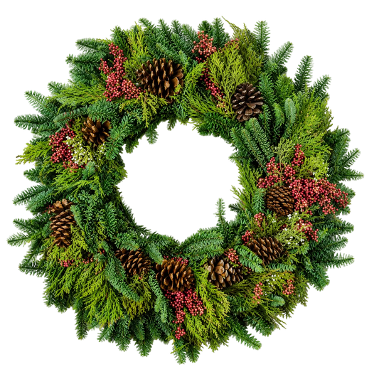 A festive Christmas wreath made of green pine and fir branches, decorated with several brown pinecones and clusters of small red berries, shown on a plain white background.